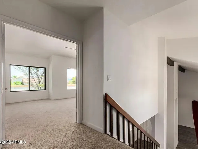 a view of hallway with windows