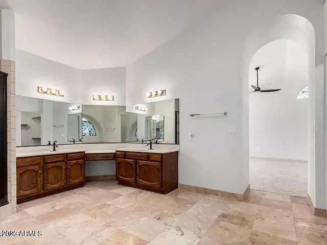 a large bathroom with a tub sink and mirror