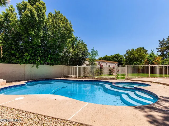 a view of a swimming pool with a lounge chair