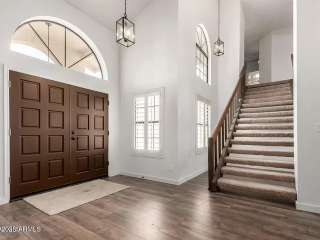 a view of an entryway with wooden floor