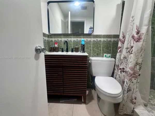 a bathroom with a toilet a sink and shower