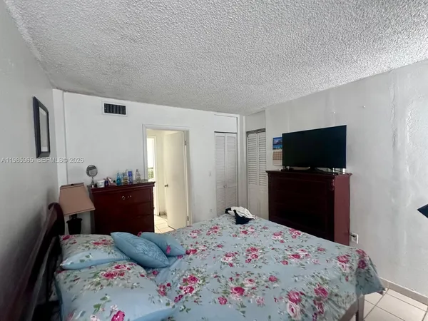 a bedroom with a bed and a lamp