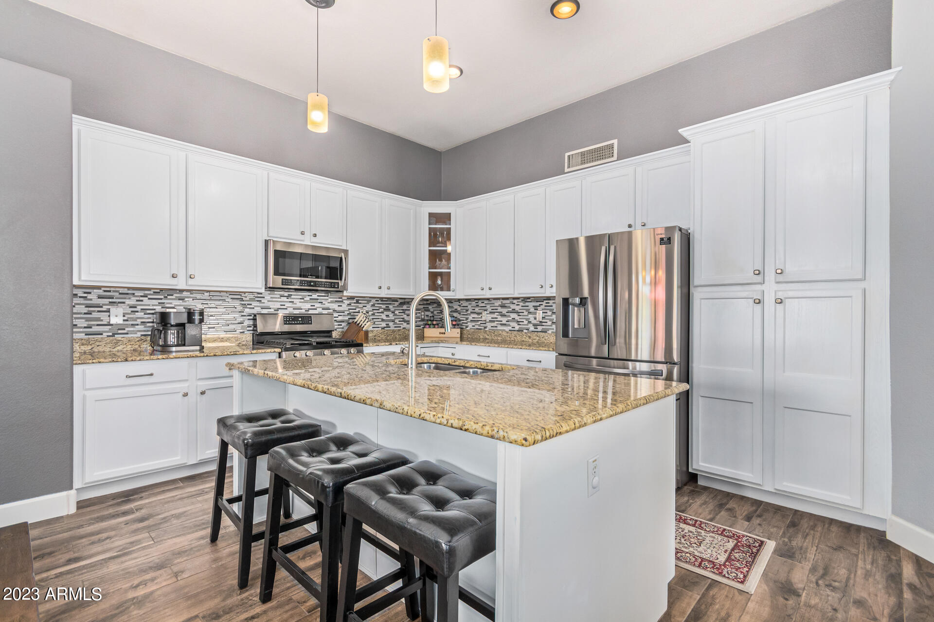 2065 South Marble Street Gilbert, AZ 85295 - Photo 12 of 59 a kitchen with kitchen island a counter top space appliances and cabinets