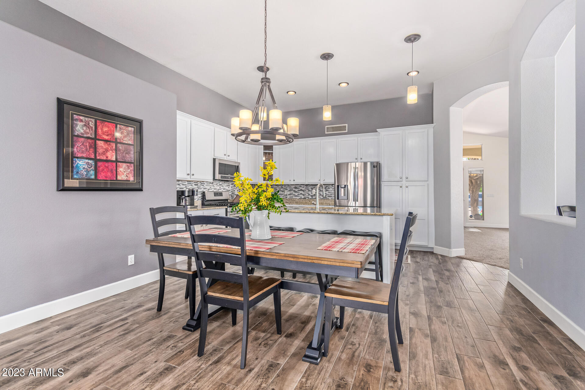 2065 South Marble Street Gilbert, AZ 85295 - Photo 16 of 59 a view of a dining room with furniture and wooden floor