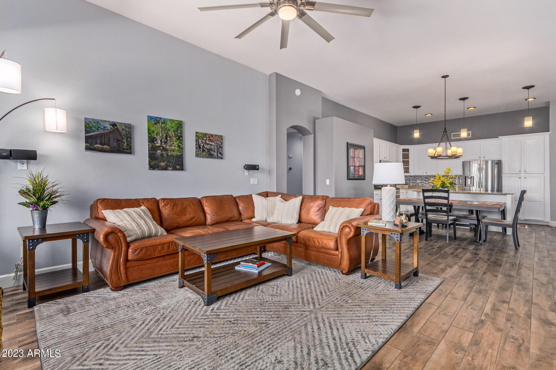 2065 South Marble Street Gilbert, AZ 85295 - Photo 20 of 59 a living room with furniture kitchen view and a wooden floor