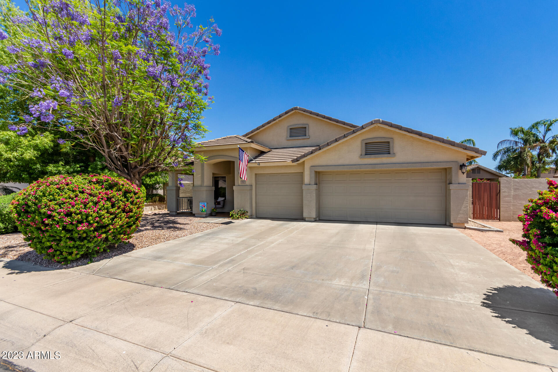 2065 South Marble Street Gilbert, AZ 85295 - Photo 2 of 59 a front view of a house with a garden