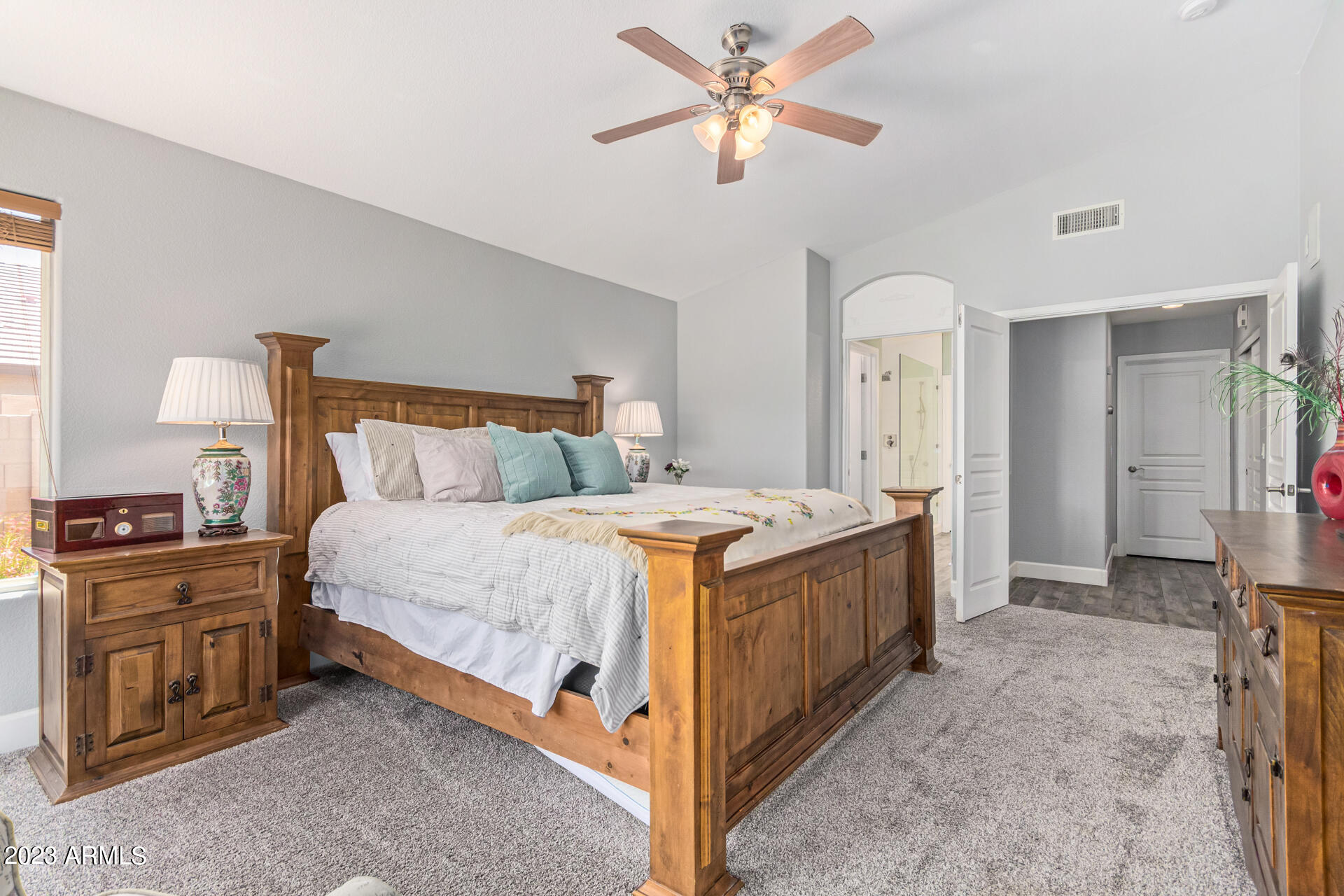 2065 South Marble Street Gilbert, AZ 85295 - Photo 22 of 59 a spacious bedroom with a bed and a chandelier