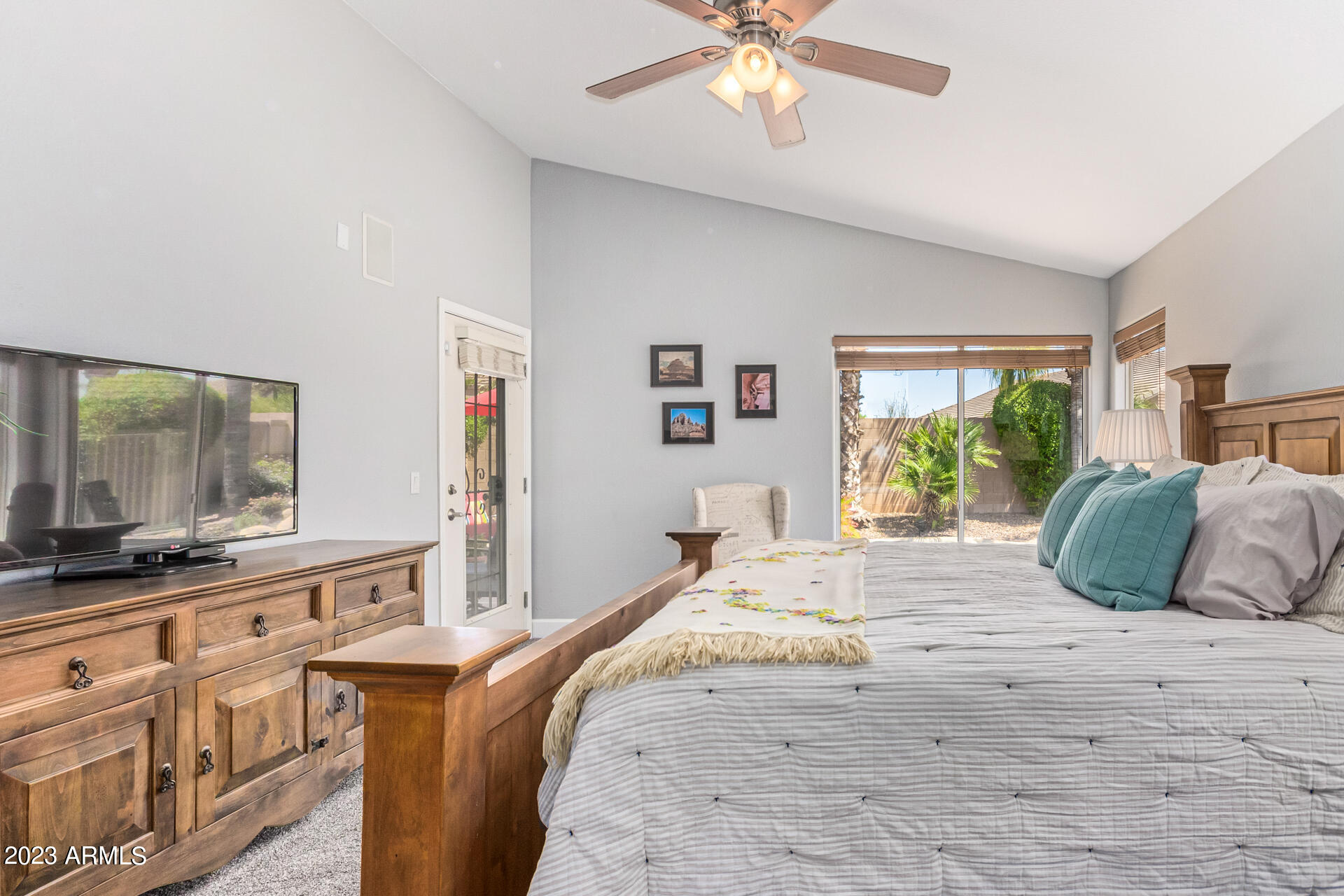 2065 South Marble Street Gilbert, AZ 85295 - Photo 23 of 59 a bedroom with a large bed and a flat tv screen on dresser