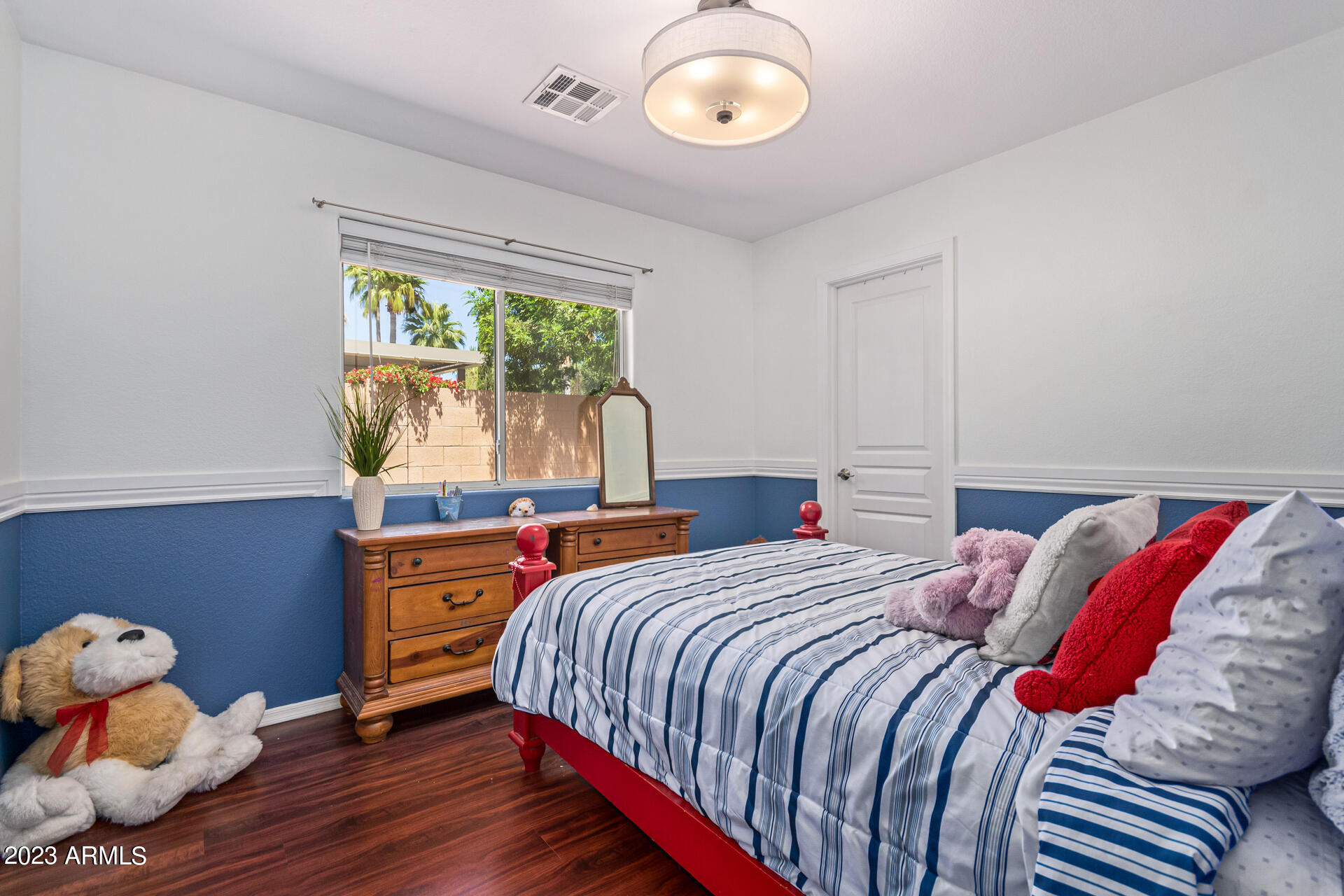 2065 South Marble Street Gilbert, AZ 85295 - Photo 27 of 59 a bedroom with a bed and wooden floor