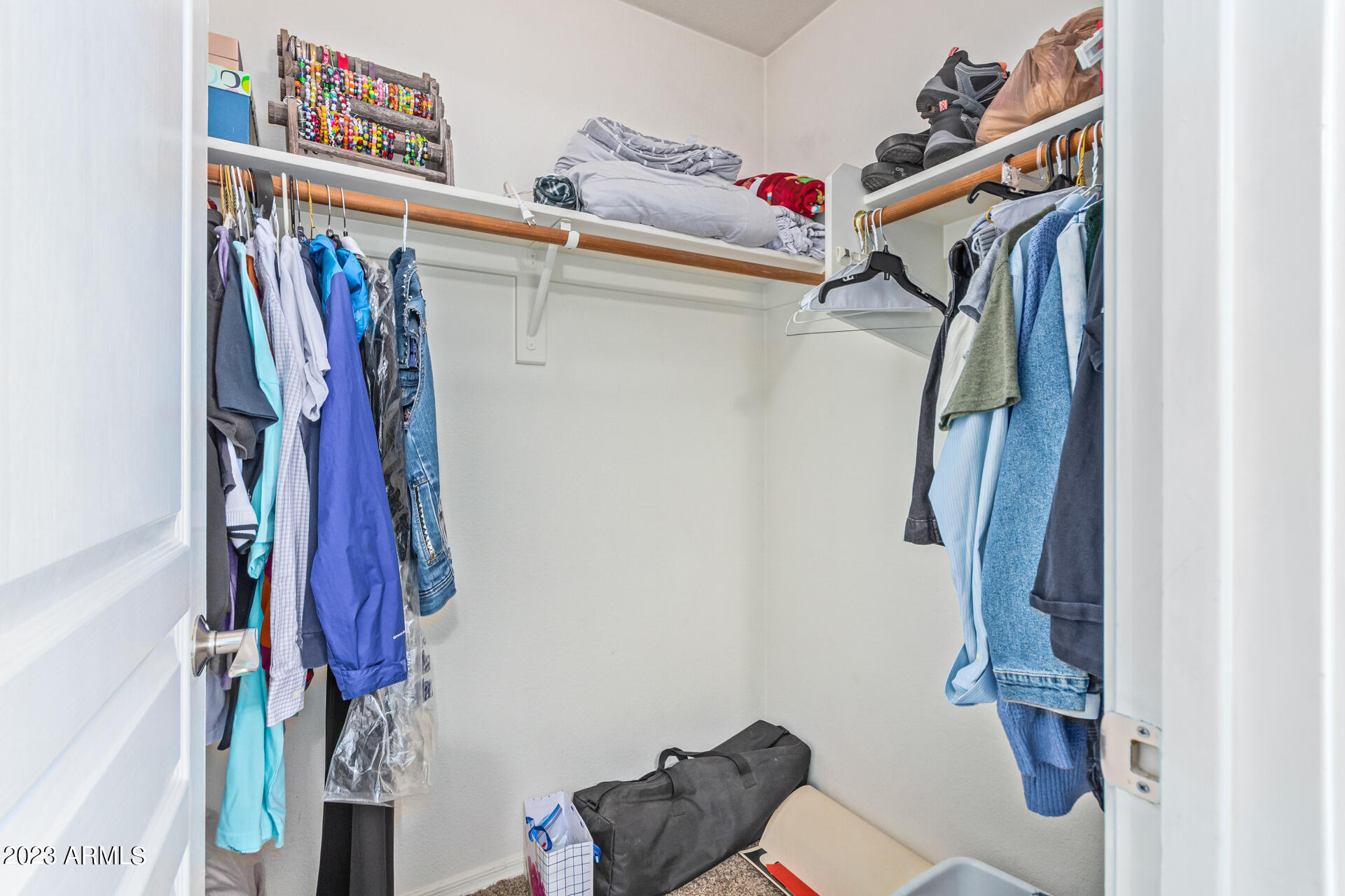 2065 South Marble Street Gilbert, AZ 85295 - Photo 30 of 59 a view of walk in closet with clothes and shoes
