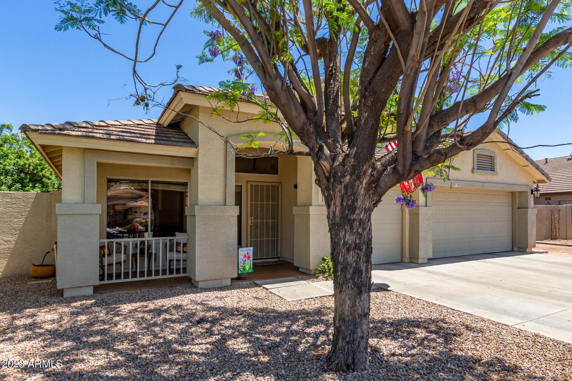 2065 South Marble Street Gilbert, AZ 85295 - Photo 3 of 59 a front view of a house with a tree