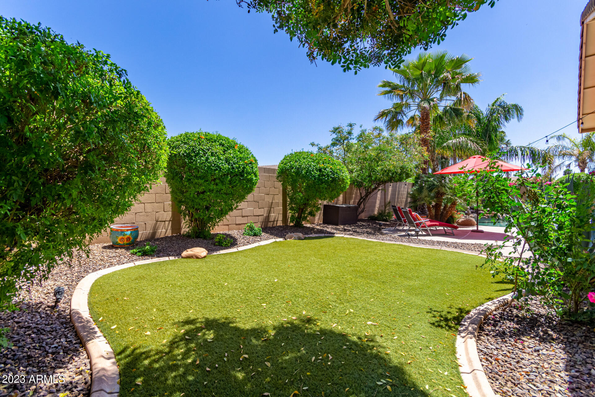 2065 South Marble Street Gilbert, AZ 85295 - Photo 42 of 59 a view of a swimming pool with an outdoor seating and a yard