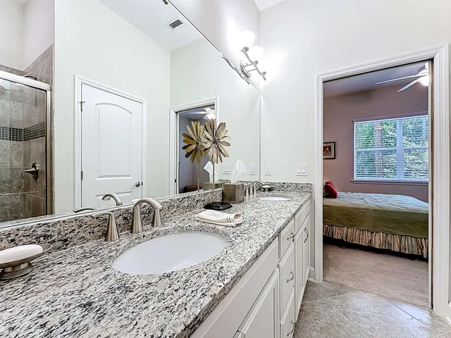 a bathroom with double vanity sinks double vanity tub and a mirror