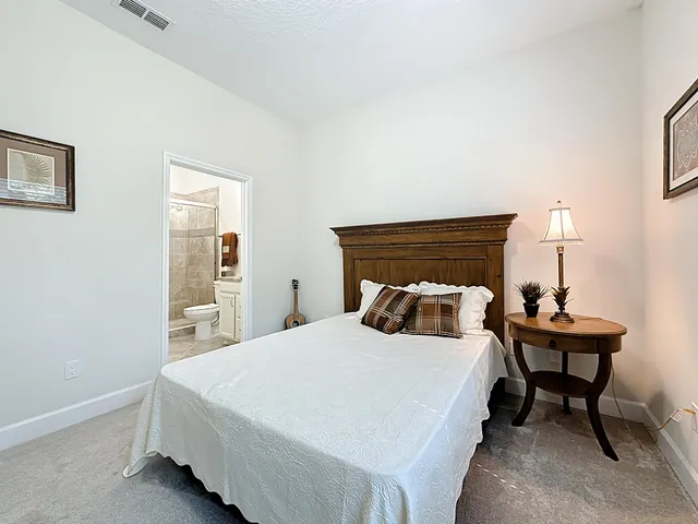 a bedroom with a bed and a night stand