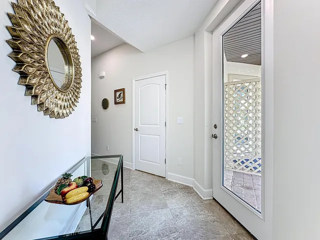 a hallway with painting on the wall and a window