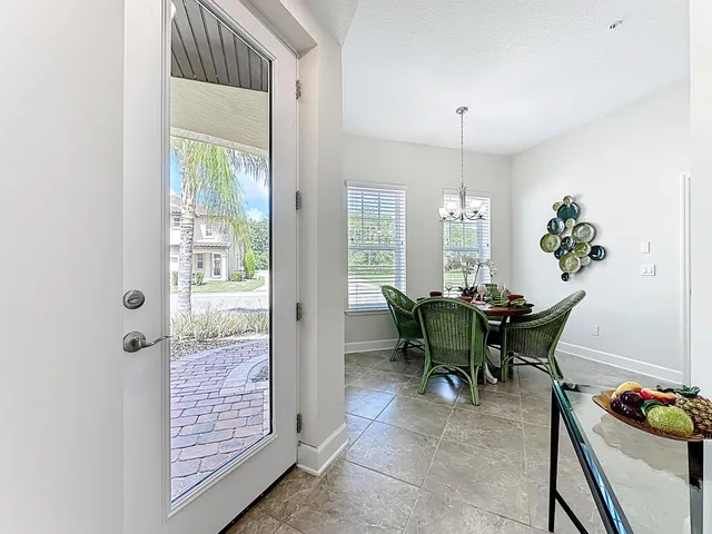 a dining room with furniture and chandelier