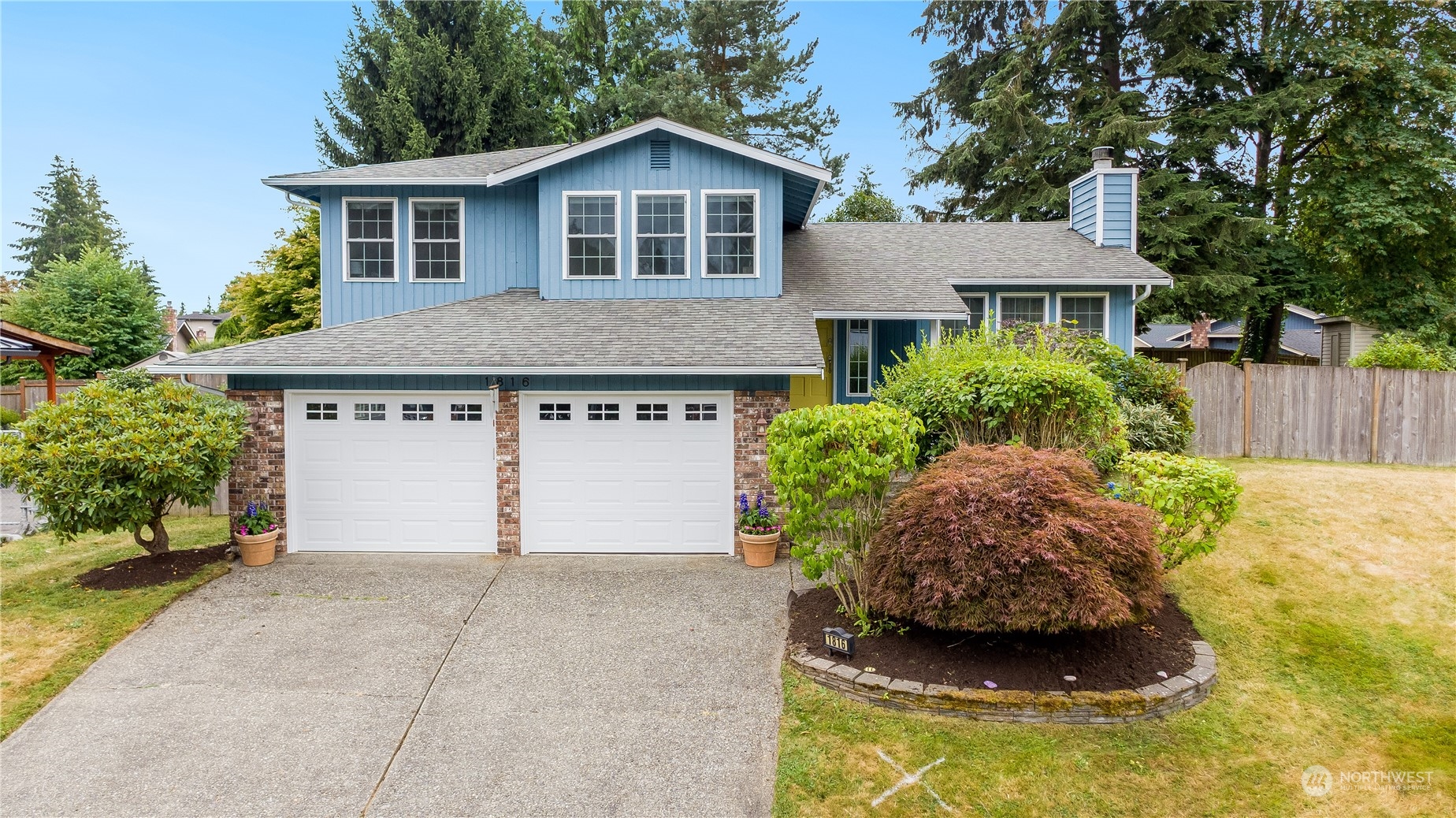 1816 243rd Place Southeast Bothell, WA 98021 - Photo 26 of 29 a front view of a house with a yard garage and outdoor seating