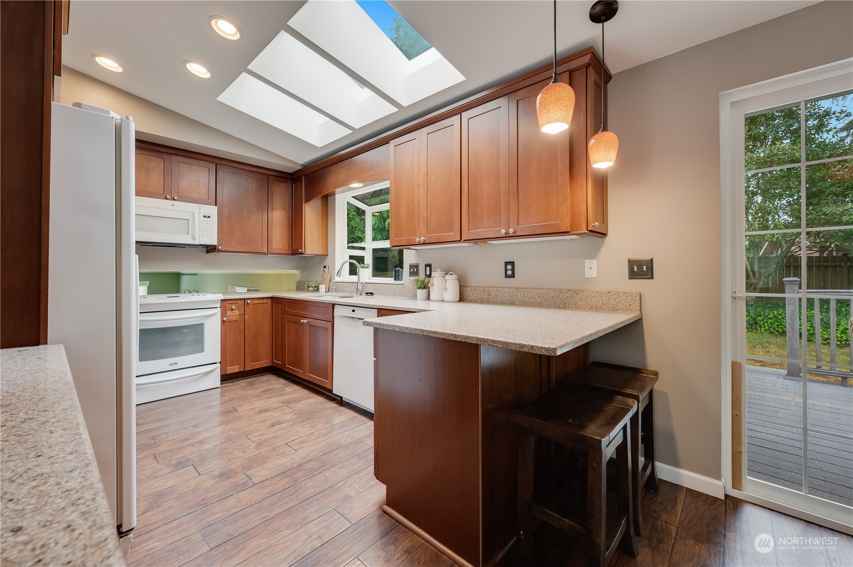 1816 243rd Place Southeast Bothell, WA 98021 - Photo 7 of 29 a kitchen with a sink window and cabinets