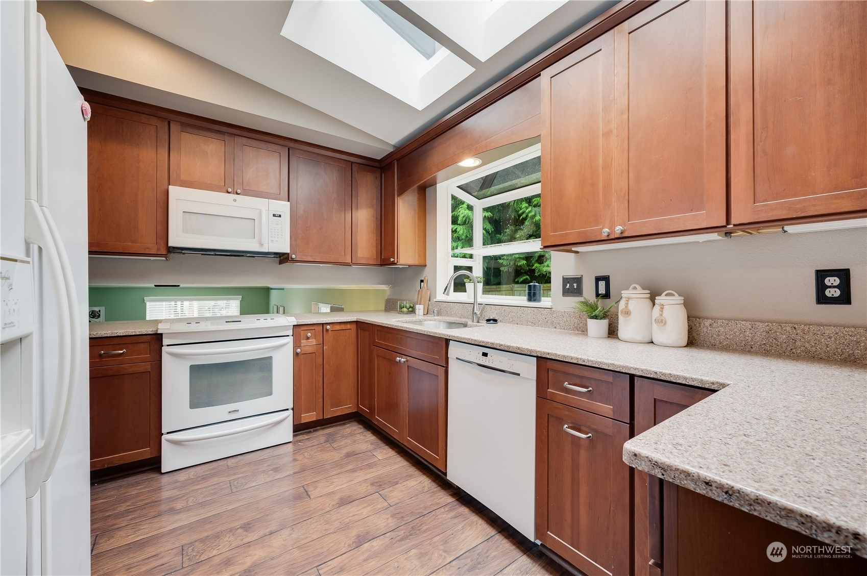 1816 243rd Place Southeast Bothell, WA 98021 - Photo 8 of 29 a kitchen with stainless steel appliances granite countertop a sink and cabinets