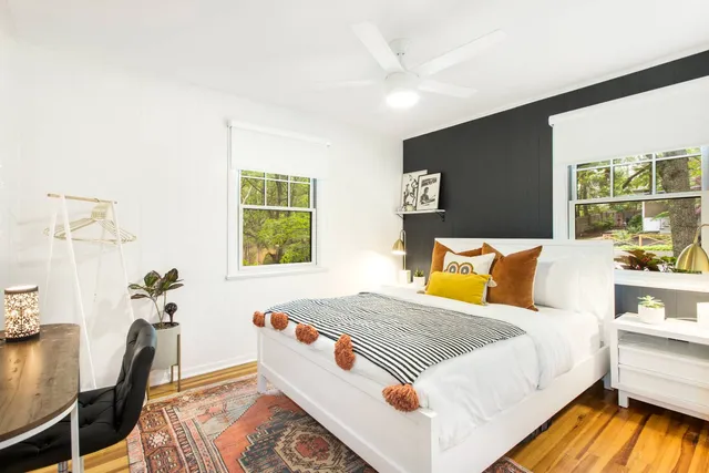 a bedroom with a bed and wooden floor