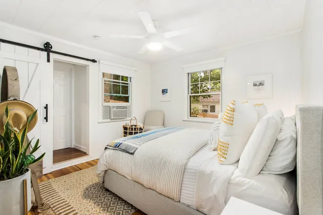 a bedroom with a bed couch and a window