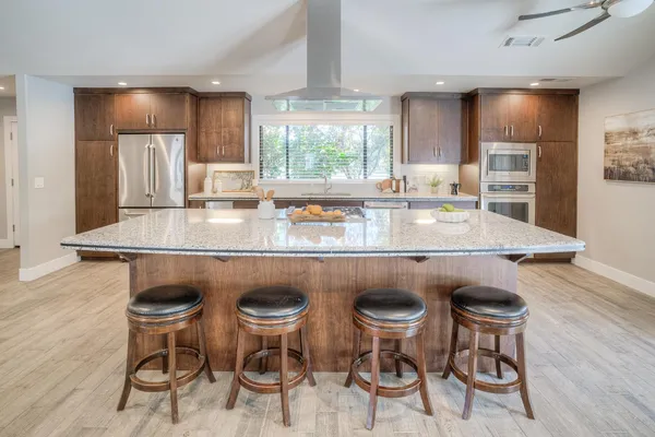 a kitchen with granite countertop a sink and a window