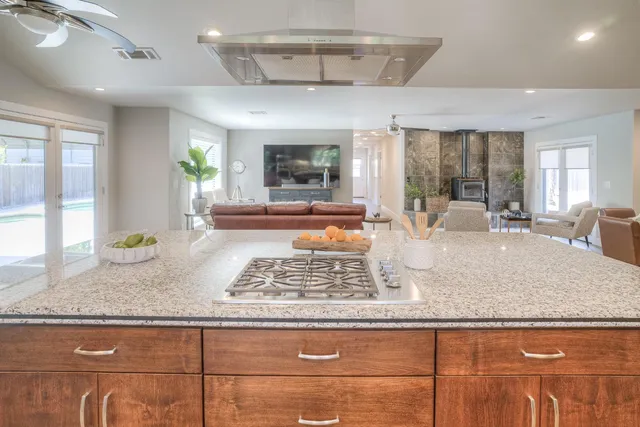 a large kitchen with kitchen island a sink appliances and a counter space