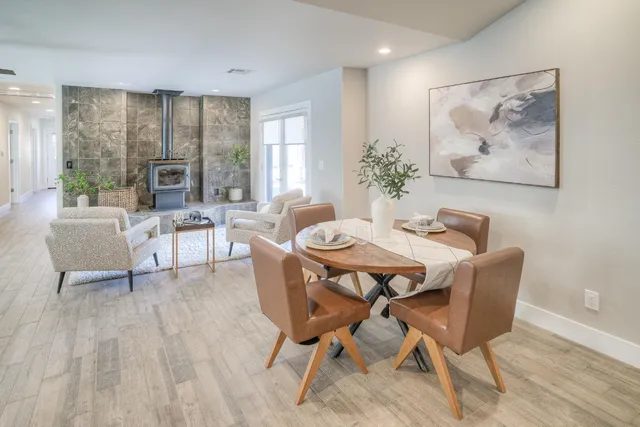 a room with stainless steel appliances kitchen island granite countertop furniture and a large window