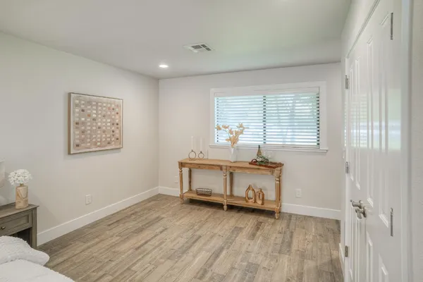 a bedroom with a bed and wooden floor