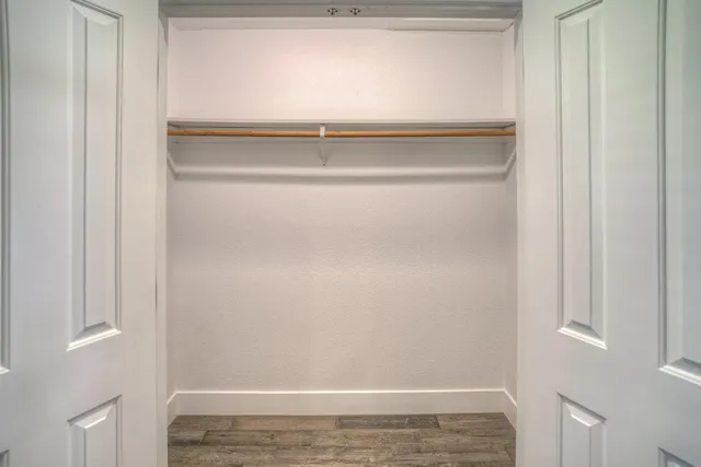 a view of a hallway with a wooden floor