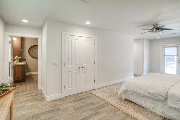 a bathroom with a sink a toilet and a large mirror