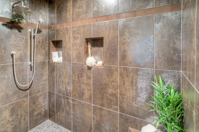 a bathroom with a granite countertop sink a shower and a mirror