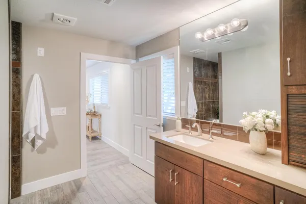 a bedroom with a bed and painting on the wall