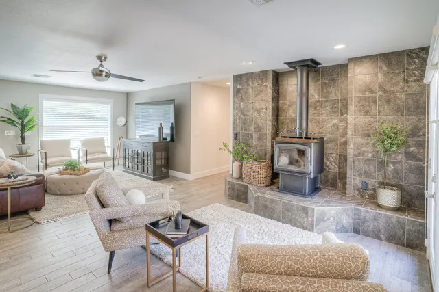 a living room with furniture kitchen view and a wooden floor