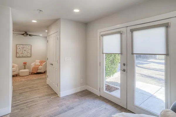 a view of a white house with a swimming pool and a chairs