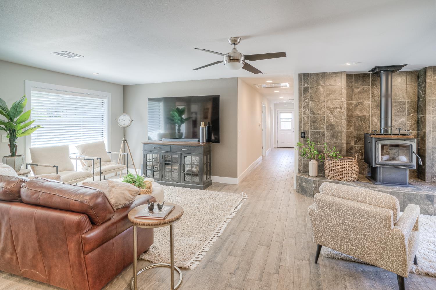 800 South Meridian Road Meridian, CA 95957 - Photo 43 of 81 a living room with furniture a fireplace and a chandelier