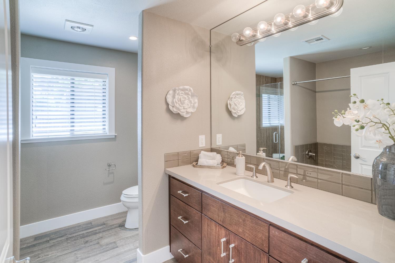 800 South Meridian Road Meridian, CA 95957 - Photo 46 of 81 a bathroom with a sink a toilet and a large mirror
