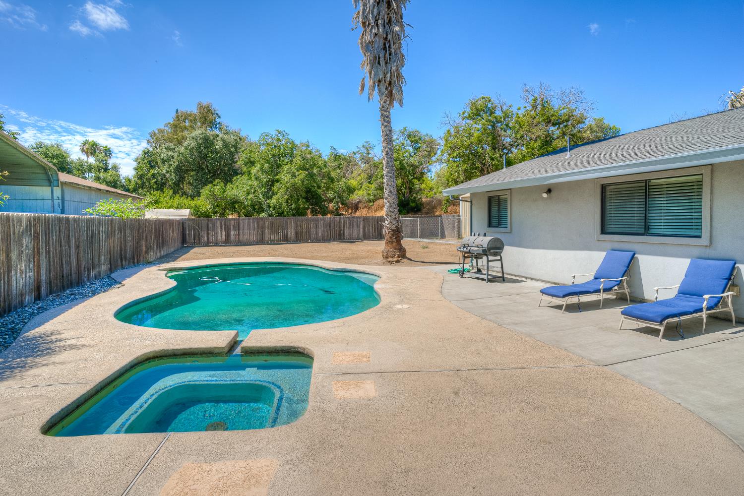 800 South Meridian Road Meridian, CA 95957 - Photo 54 of 81 a view of a backyard with table and chairs under an umbrella with wooden fence