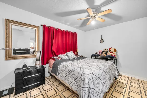 a bedroom with two beds and a chandelier