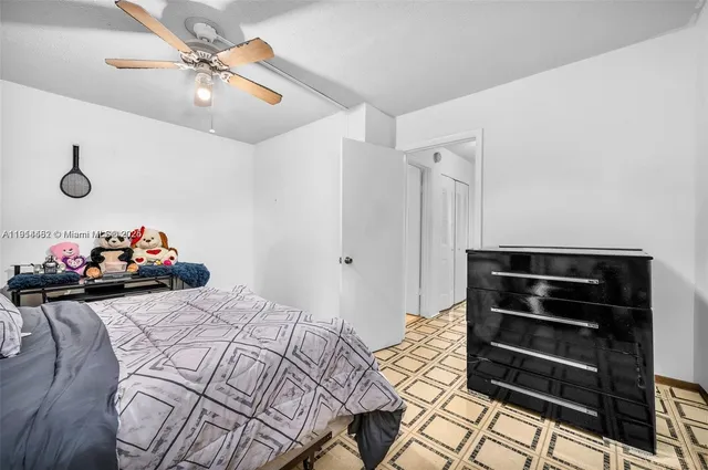 a bedroom with a bed and cabinets