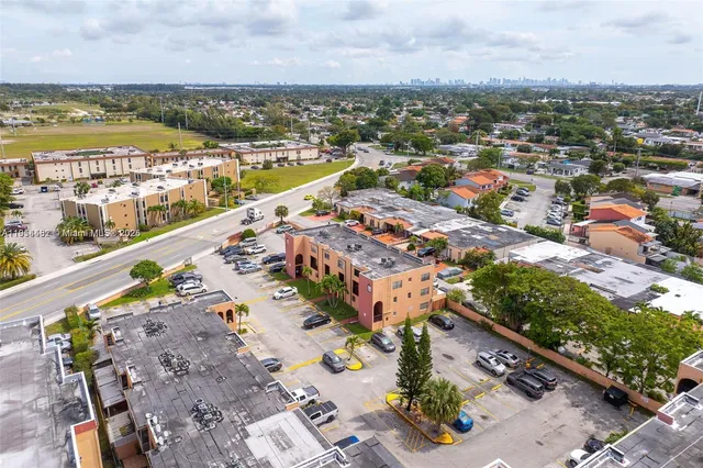 an aerial view of residential building and lake