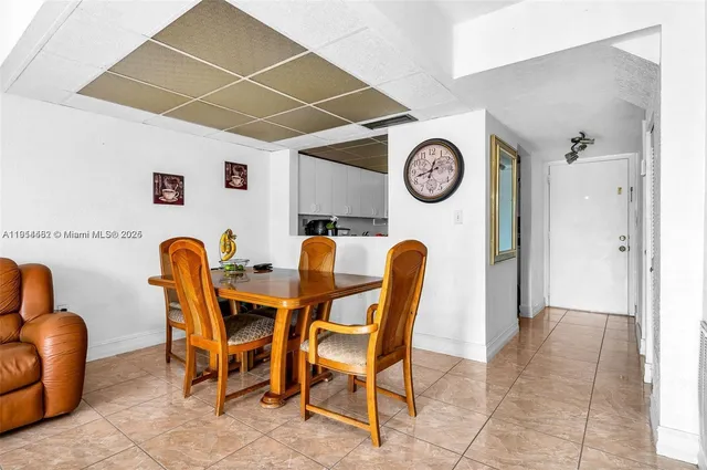 a view of a dining area with furniture and a clock