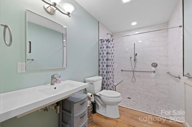 a bathroom with a sink toilet and shower