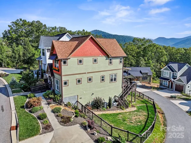 an aerial view of a house with swimming pool garden and patio