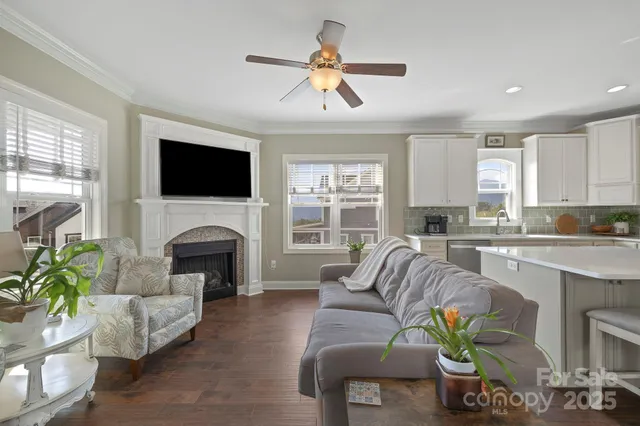 a living room with furniture a fireplace and a flat screen tv