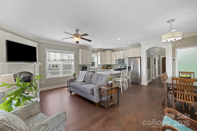 a living room with furniture fireplace and flat screen tv