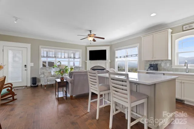 a living room with furniture a flat screen tv and a window