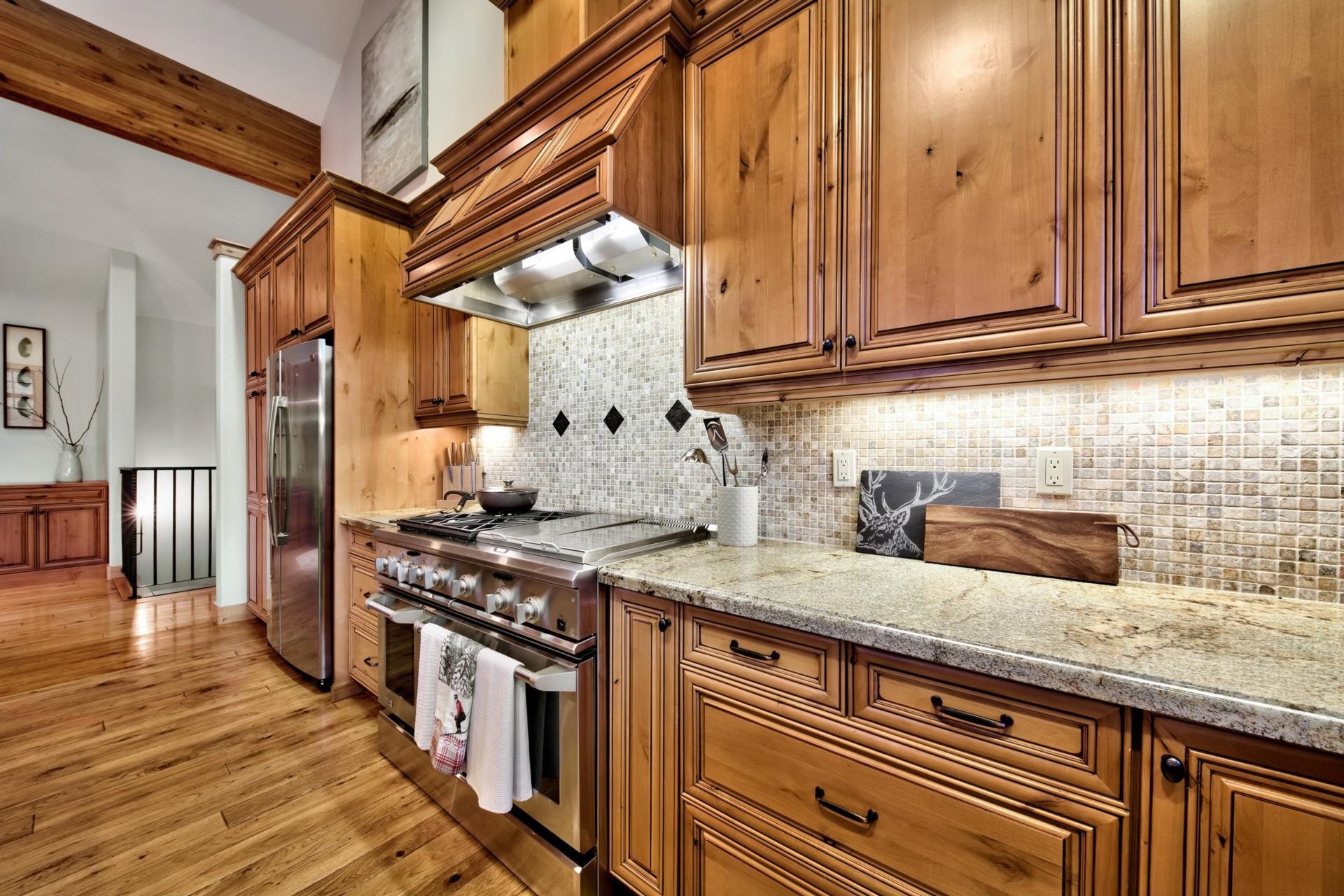 10239 Valmont Trail Truckee, CA 96161 - Photo 12 of 21 a kitchen with stainless steel appliances granite countertop a sink a stove and a wooden cabinets