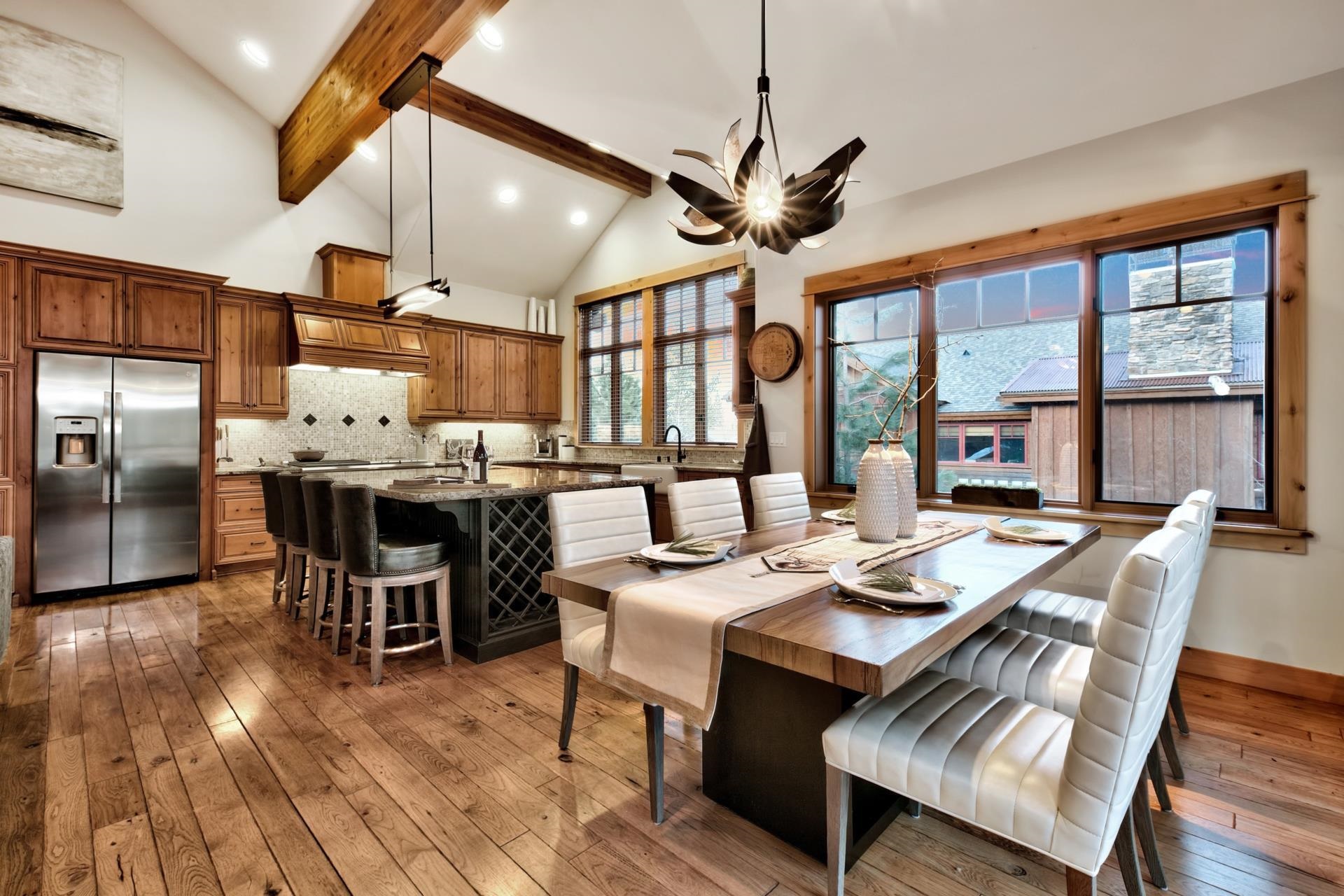 10239 Valmont Trail Truckee, CA 96161 - Photo 9 of 21 a dining room with stainless steel appliances granite countertop a table chairs and a chandelier
