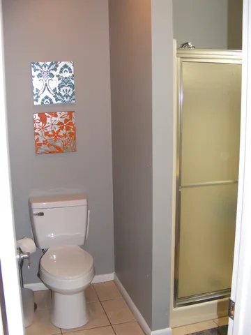 a bathroom with a toilet and a shower